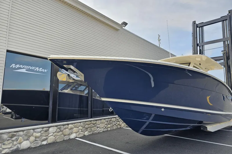 Slide: The Image of 2024 Scout 305 LXF boat displayed at MarineMax dealership. - 6