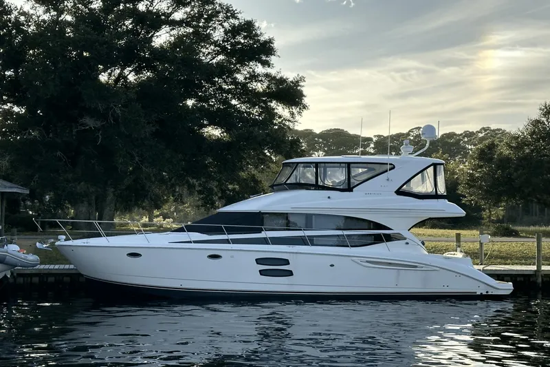 Slide: The Image of 2015 Meridian 441 Sedan yacht docked by a scenic waterfront. - 0