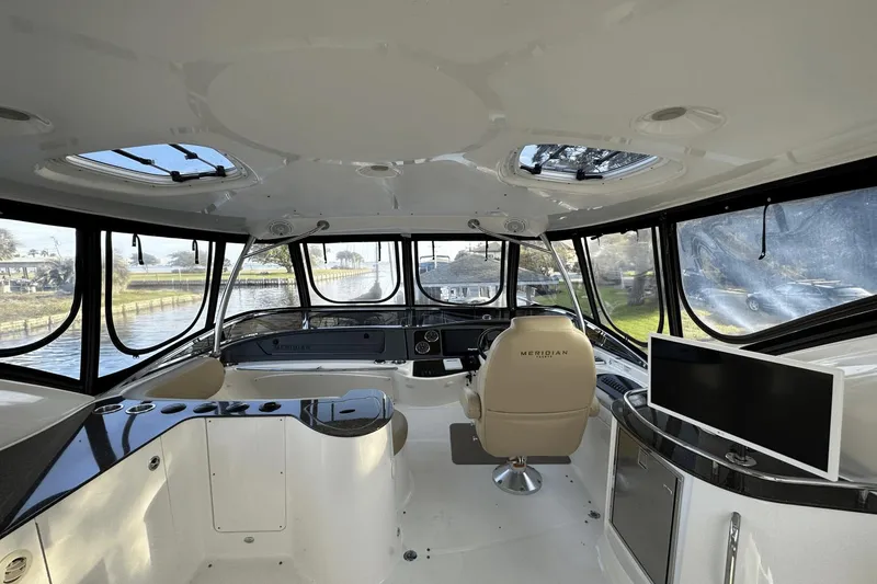 Slide: The Image of Interior of 2015 Meridian 441 Sedan yacht with panoramic windows and modern helm. - 11