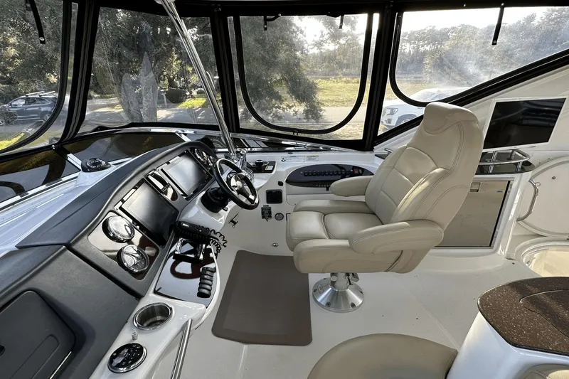 Slide: The Image of 2015 Meridian 441 Sedan helm with leather captain's chair and modern navigation controls. - 12