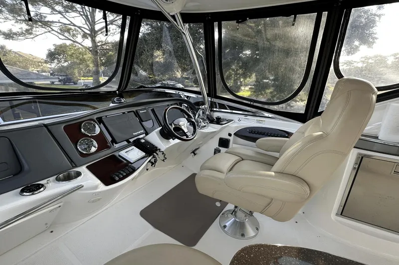 Slide: The Image of Interior of 2015 Meridian 441 Sedan yacht cockpit with steering wheel and control panel. - 13