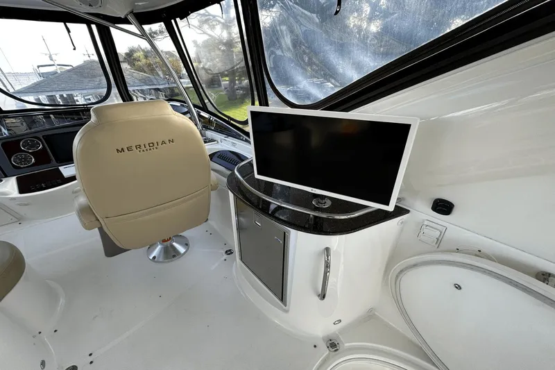 Slide: The Image of Interior of 2015 Meridian 441 Sedan yacht with helm chair and mounted TV. - 14