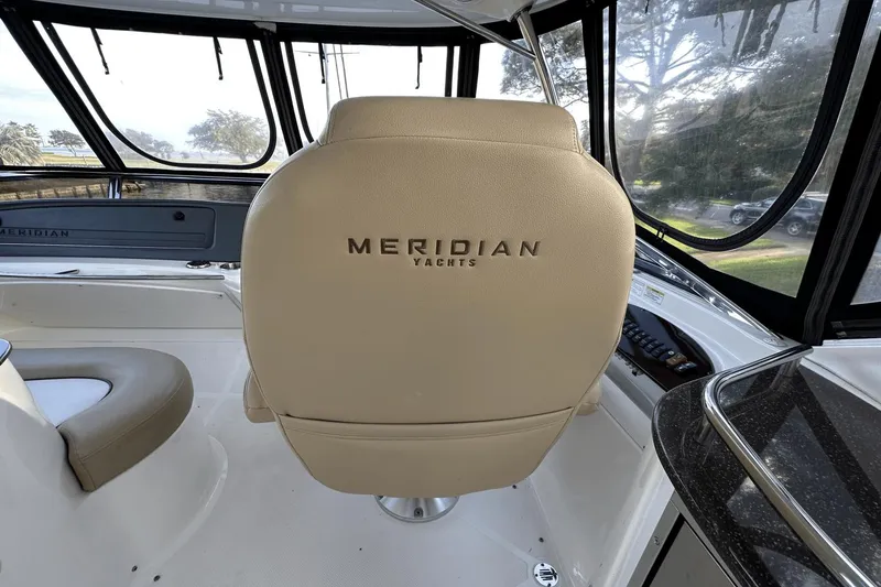 Slide: The Image of Interior of 2015 Meridian 441 Sedan yacht with beige seating and panoramic windows. - 16