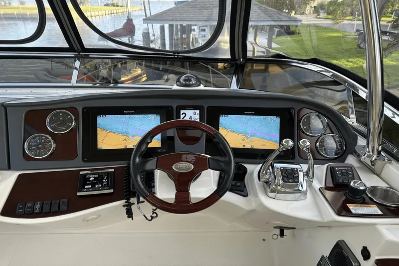 Slide: The Image of 2015 Meridian 441 Sedan helm with navigation screens and controls. - 19