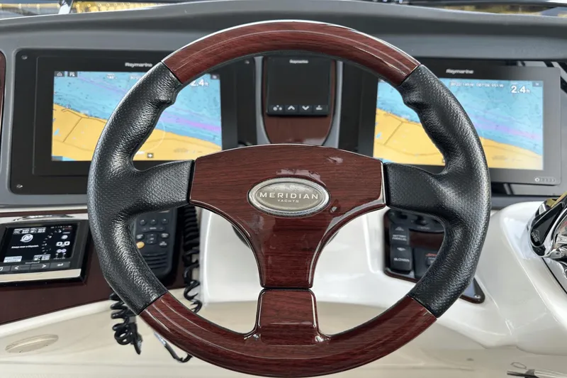 Slide: The Image of Steering wheel of 2015 Meridian 441 Sedan yacht with navigation screens. - 23