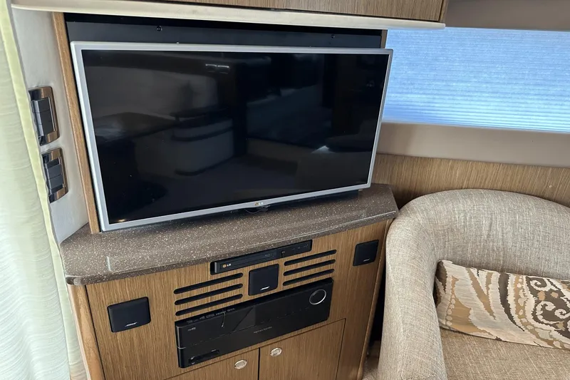 Slide: The Image of Entertainment system in 2015 Meridian 441 Sedan yacht interior with TV and seating area. - 38