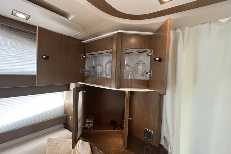 Slide: The Image of Interior of 2015 Meridian 441 Sedan with open wooden cabinets and glassware. - 39