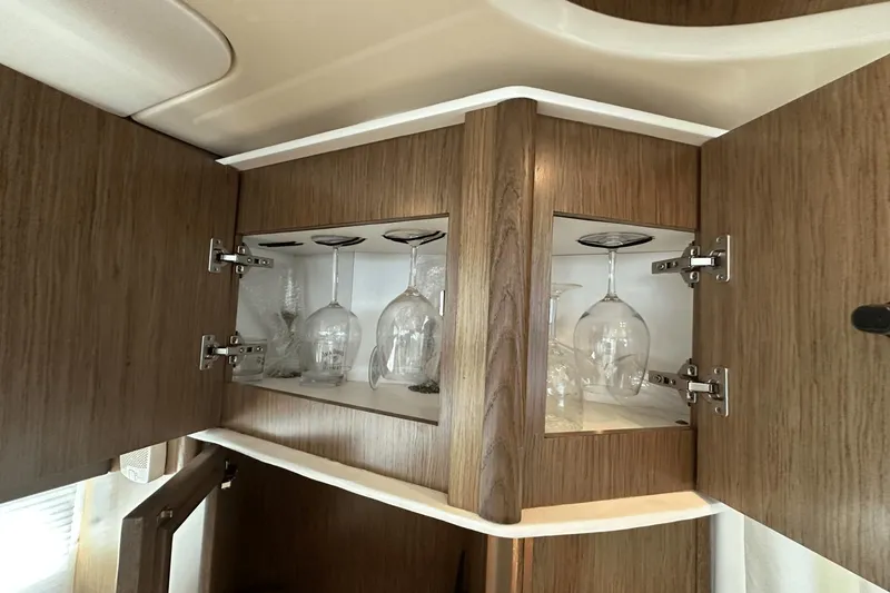 Slide: The Image of Wooden cabinet with glassware inside, aboard a 2015 Meridian 441 Sedan yacht. - 40
