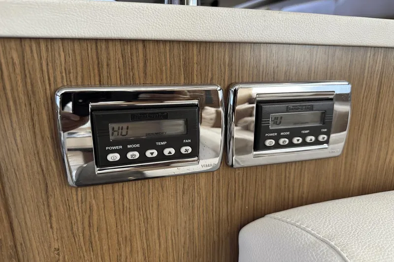 Slide: The Image of Digital control panels on a 2015 Meridian 441 Sedan yacht interior. - 43
