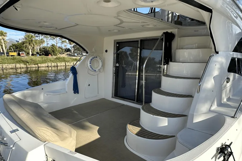 Slide: The Image of 2015 Meridian 441 Sedan yacht interior with curved stairs and seating area. - 8