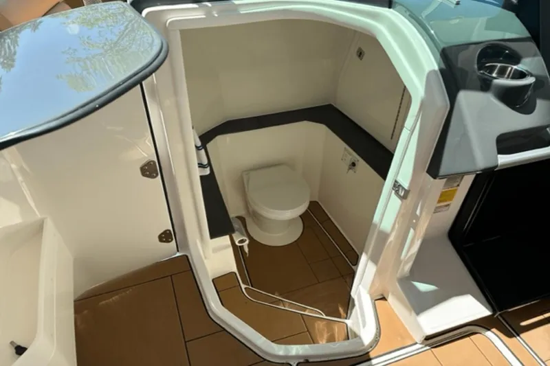 Slide: The Image of 2022 Aviara AV32 Outboard boat interior with compact bathroom and toilet. - 10