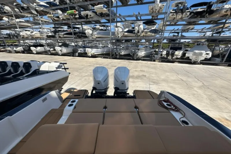 Slide: The Image of 2022 Aviara AV32 Outboard boat with dual engines in storage facility. - 14