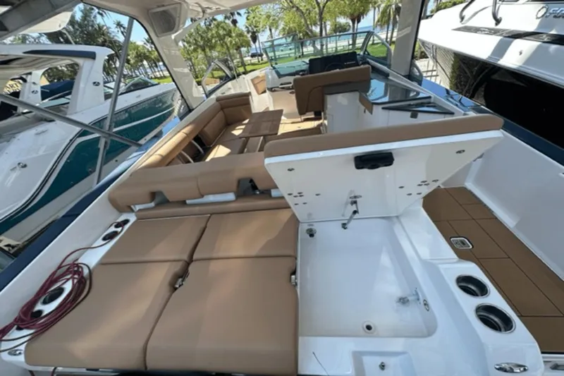 Slide: The Image of 2022 Aviara AV32 Outboard boat interior with tan seating and modern amenities. - 16