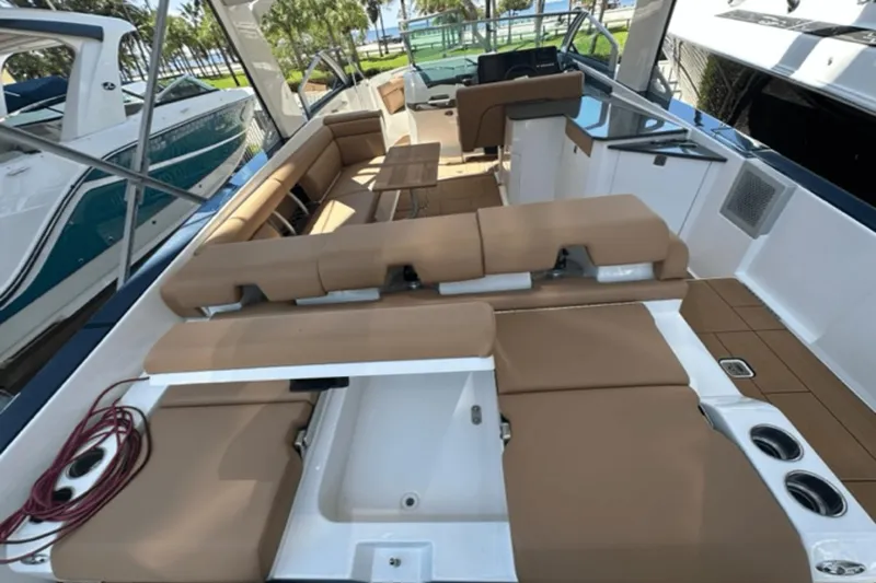Slide: The Image of 2022 Aviara AV32 Outboard boat interior with tan seating and modern design. - 18