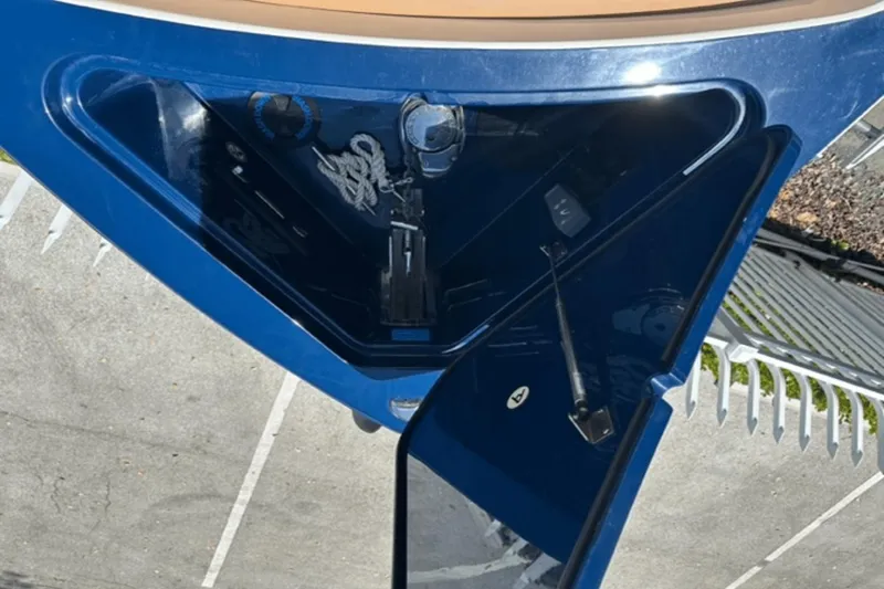 Slide: The Image of Aviara AV32 Outboard 2022 boat storage compartment with rope and equipment. - 2