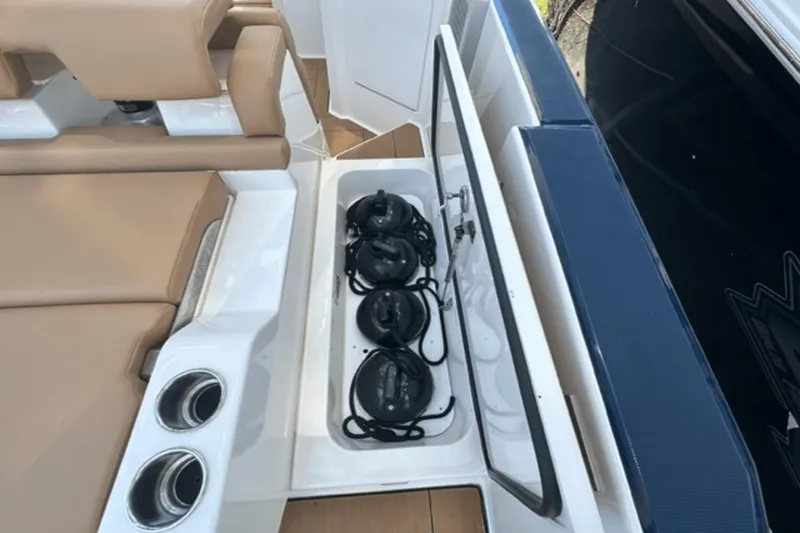 Slide: The Image of 2022 Aviara AV32 Outboard boat storage compartment with ropes and cup holders. - 23