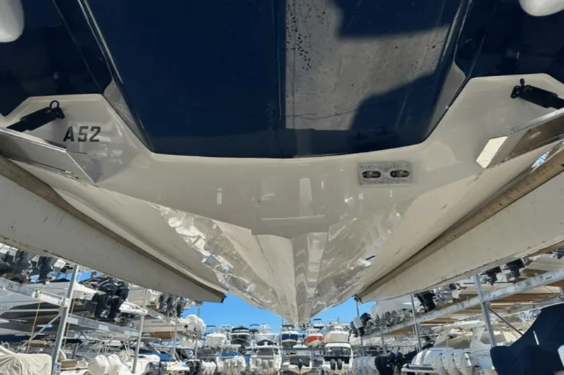 Slide: The Image of 2022 Aviara AV32 Outboard boat hull in storage, surrounded by other boats. - 27