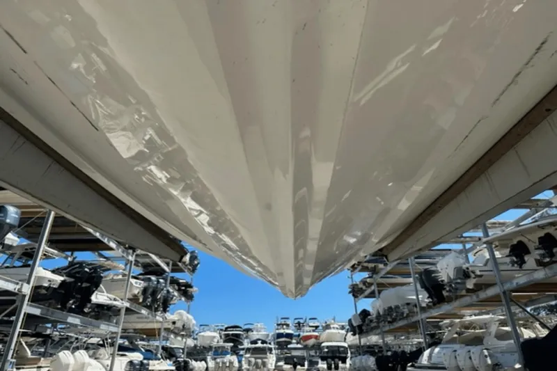 Slide: The Image of 2022 Aviara AV32 Outboard boat stored in a marina with multiple vessels. - 28