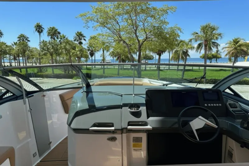 Slide: The Image of Interior view of 2022 Aviara AV32 Outboard boat with scenic palm tree backdrop. - 3