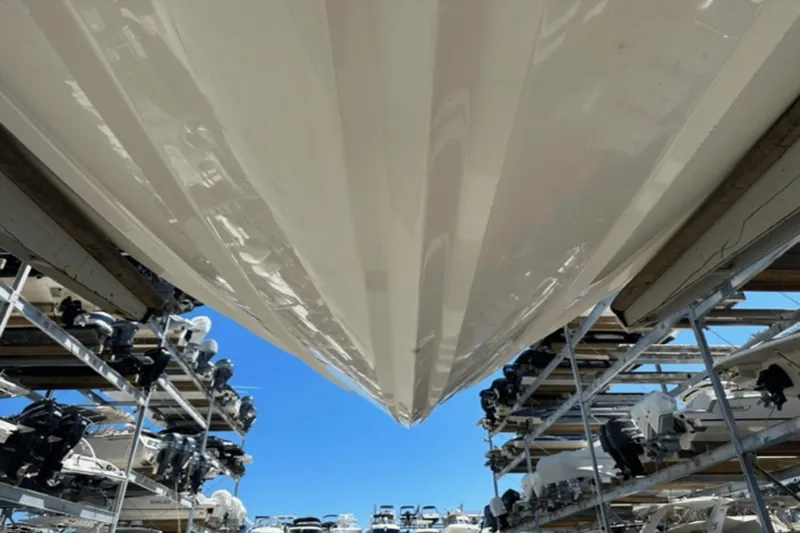 Slide: The Image of 2022 Aviara AV32 Outboard boat stored in a marina with clear blue sky. - 30