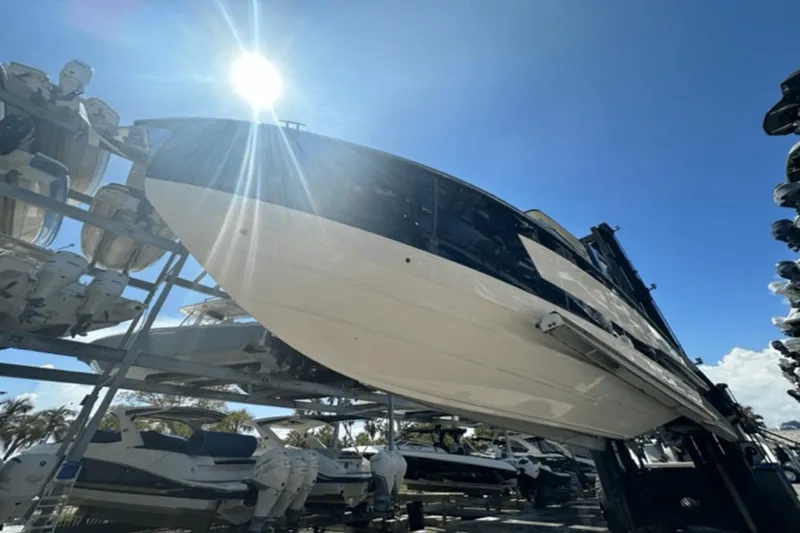 Slide: The Image of 2022 Aviara AV32 Outboard boat on rack under bright sun. - 31