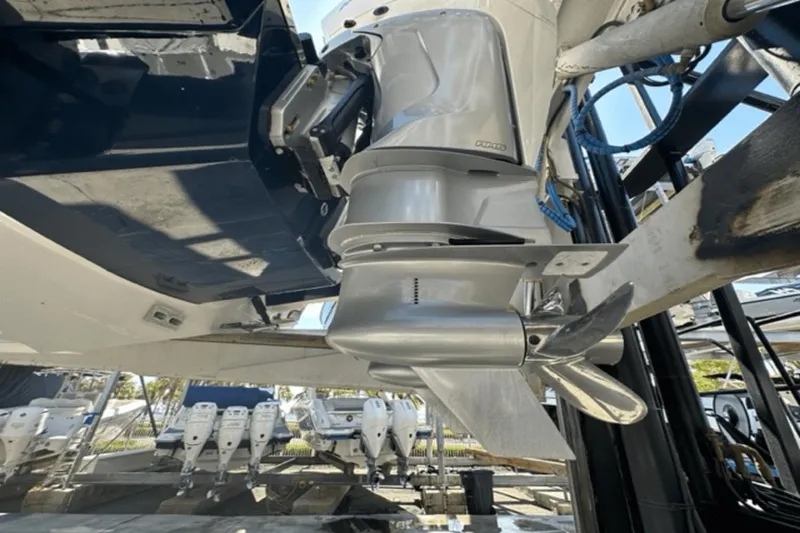 Slide: The Image of Close-up of 2022 Aviara AV32 Outboard motor and propeller in a marina setting. - 32