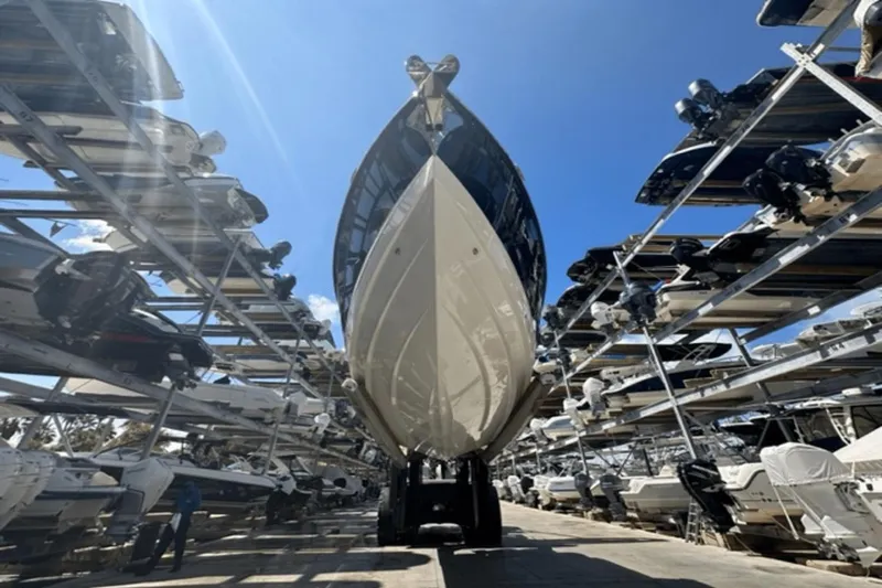 Slide: The Image of 2022 Aviara AV32 Outboard boat in storage facility under clear blue sky. - 33