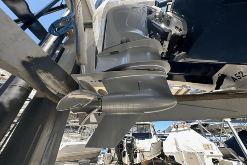 Slide: The Image of Close-up of 2022 Aviara AV32 Outboard motor and propeller in a marina setting. - 36