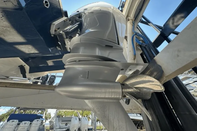 Slide: The Image of 2022 Aviara AV32 Outboard motor close-up with propeller in marina setting. - 38