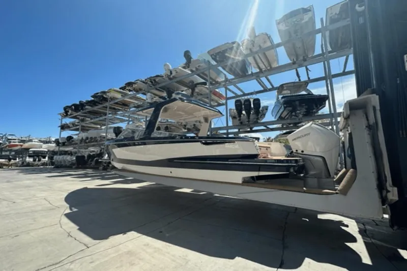 Slide: The Image of 2022 Aviara AV32 Outboard boat in storage facility under clear blue sky. - 42