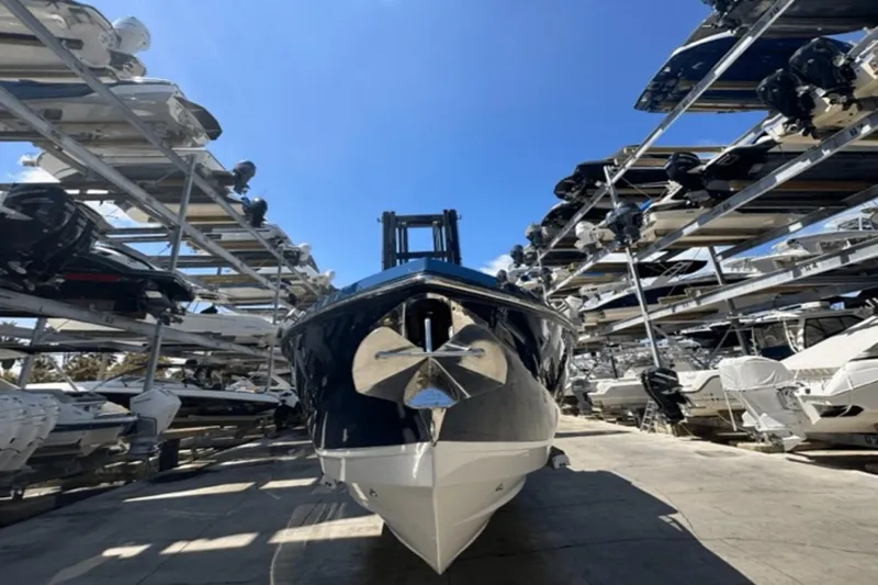 Slide: The Image of 2022 Aviara AV32 Outboard boat in storage facility under clear blue sky. - 44