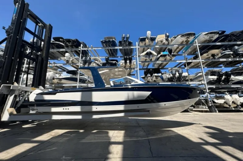 Slide: The Image of 2022 Aviara AV32 Outboard boat in storage facility, surrounded by other boats. - 45