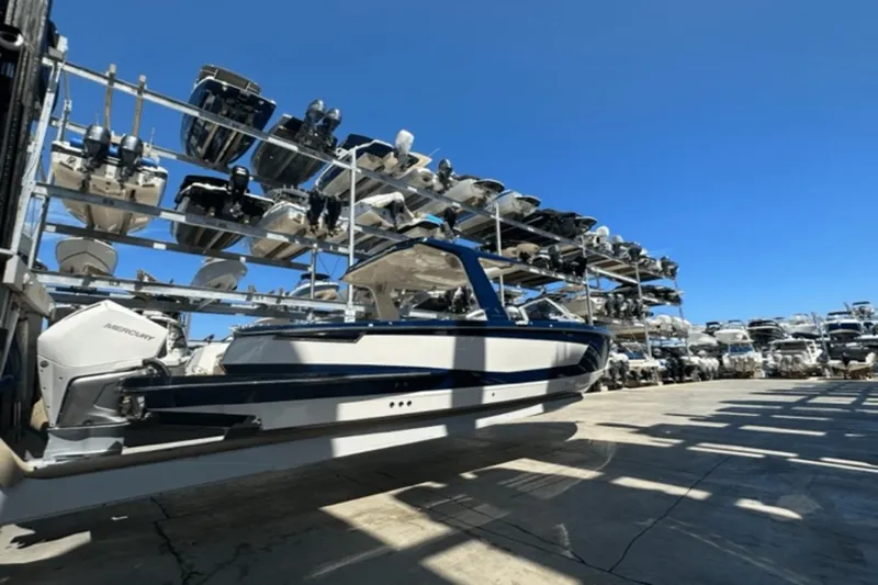 Slide: The Image of 2022 Aviara AV32 Outboard boat in storage facility under clear blue sky. - 46
