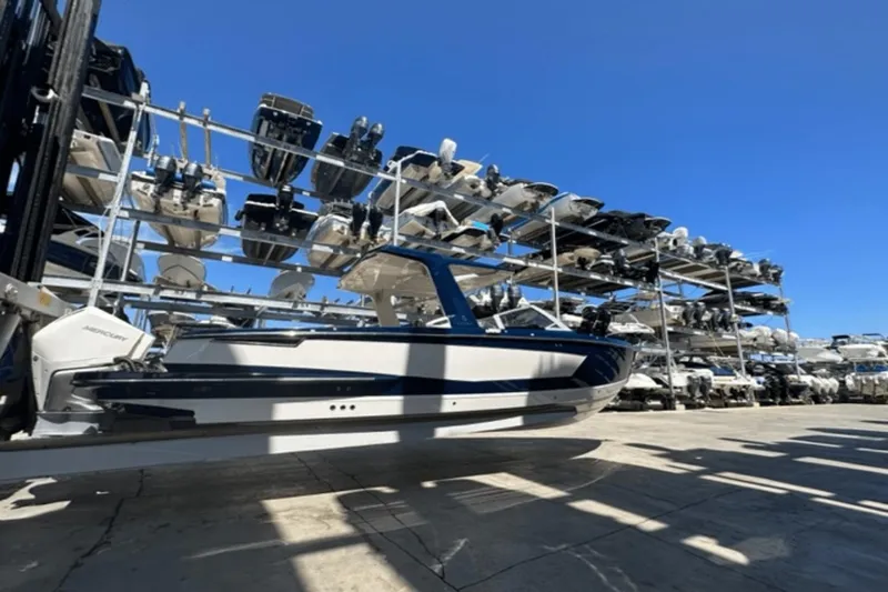 Slide: The Image of 2022 Aviara AV32 Outboard boat in storage facility under clear blue sky. - 47