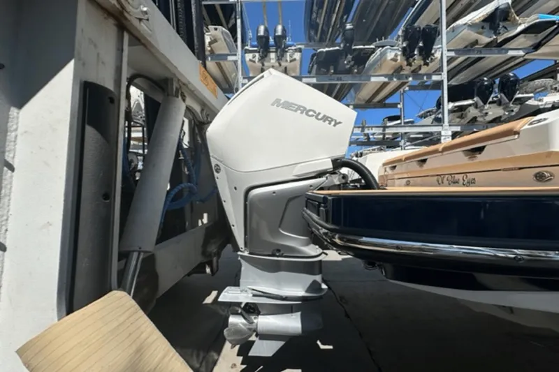 Slide: The Image of 2022 Aviara AV32 Outboard with Mercury engine in a boat storage facility. - 48