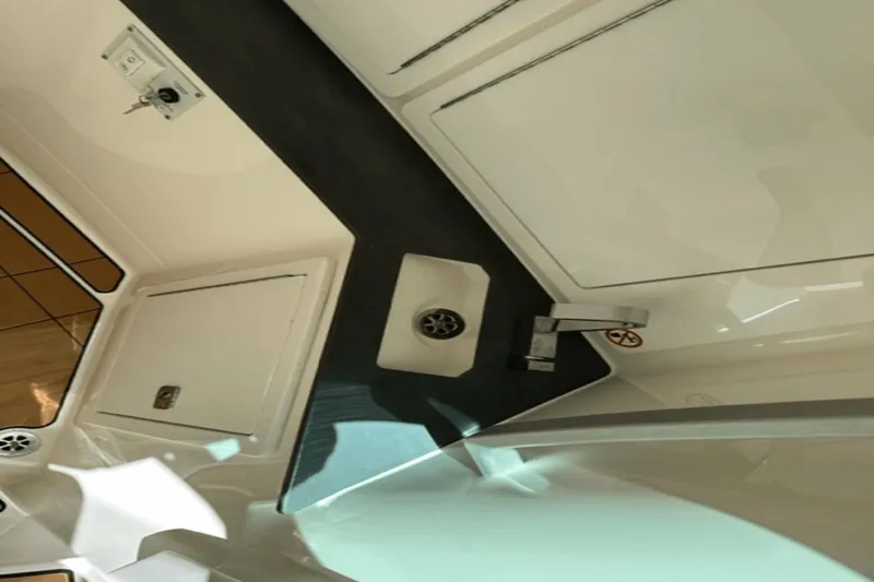 Slide: The Image of Interior view of 2022 Aviara AV32 Outboard boat, featuring sleek cabinetry and modern fixtures. - 7