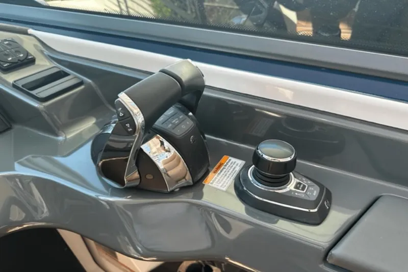 Slide: The Image of 2022 Aviara AV32 Outboard helm controls with joystick and throttle. - 8