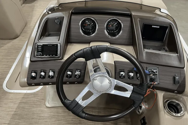 Slide: The Image of 2019 Bennington 23RSBDN boat dashboard with steering wheel and control panel. - 13