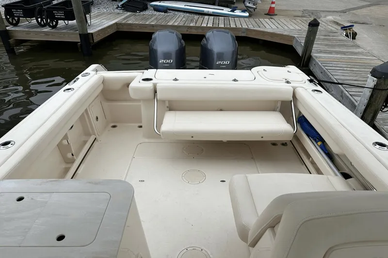 Slide: The Image of 2022 Grady-White 275 Freedom boat interior at dock, featuring dual engines. - 11