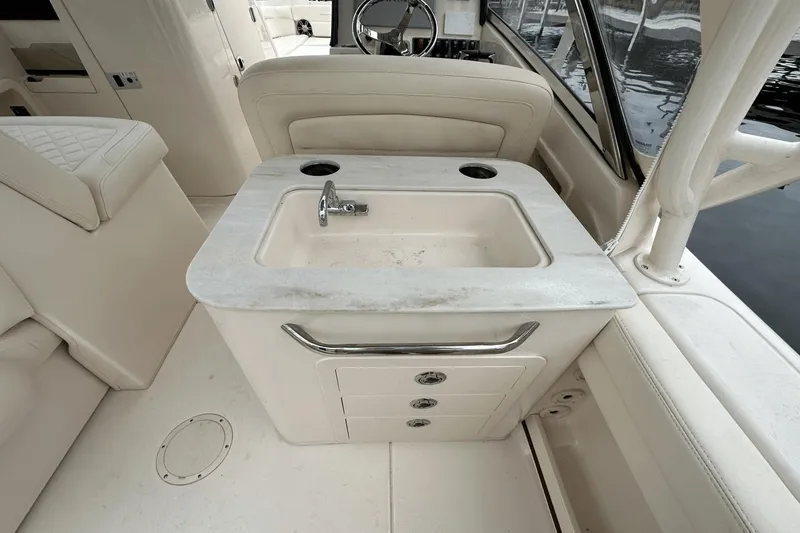 Slide: The Image of 2022 Grady-White 275 Freedom boat interior with sink and storage drawers. - 13