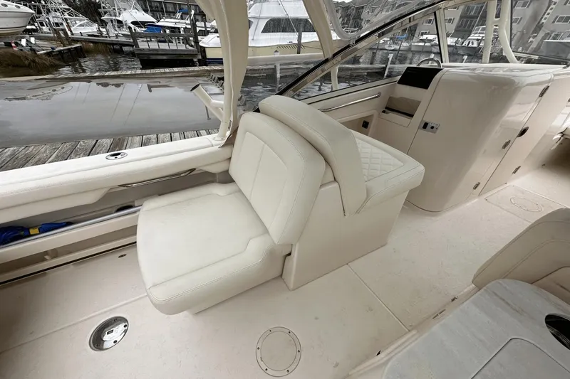 Slide: The Image of 2022 Grady-White 275 Freedom boat interior with white seating and helm station. - 15