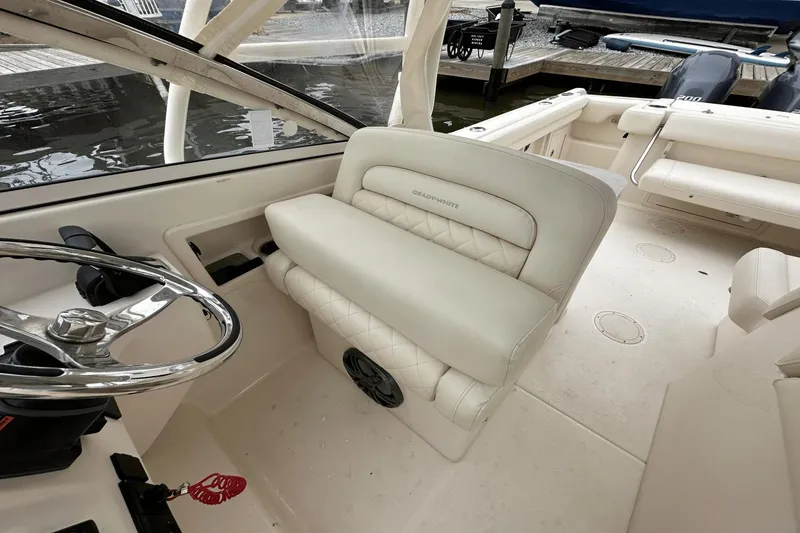 Slide: The Image of 2022 Grady-White 275 Freedom boat interior with steering wheel and seating. - 18