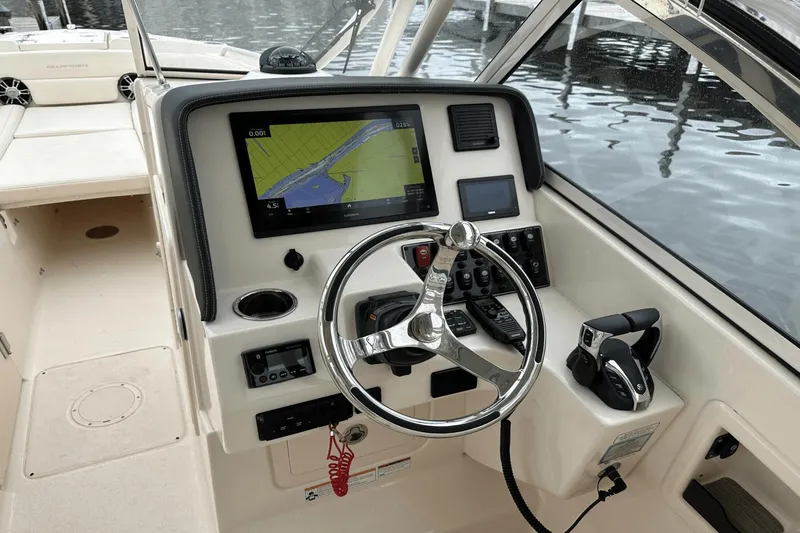 Slide: The Image of Grady-White 275 Freedom 2022 boat helm with navigation display and controls. - 22