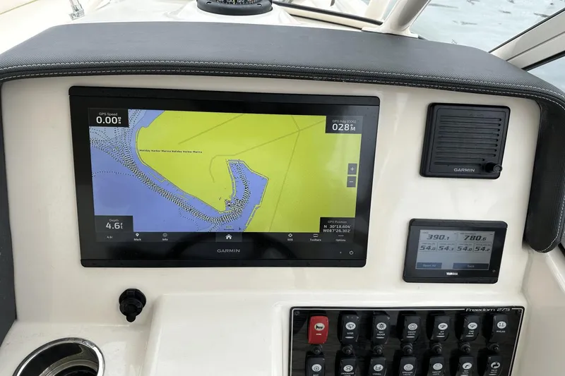 Slide: The Image of 2022 Grady-White 275 Freedom boat dashboard with Garmin navigation display. - 23