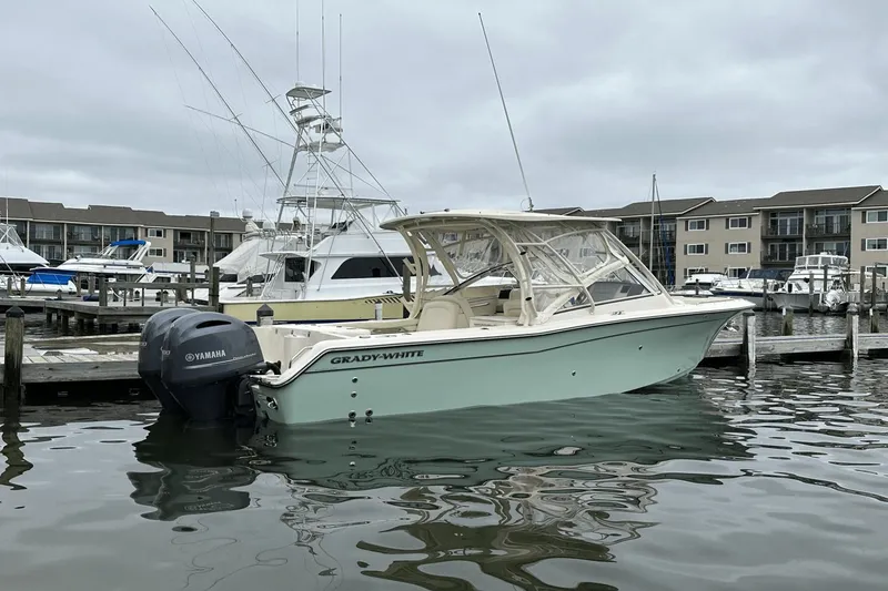 Slide: The Image of 2022 Grady-White 275 Freedom boat docked in marina, overcast sky. - 3