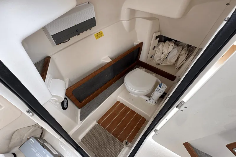 Slide: The Image of 2022 Grady-White 275 Freedom boat interior bathroom with toilet and storage space. - 31