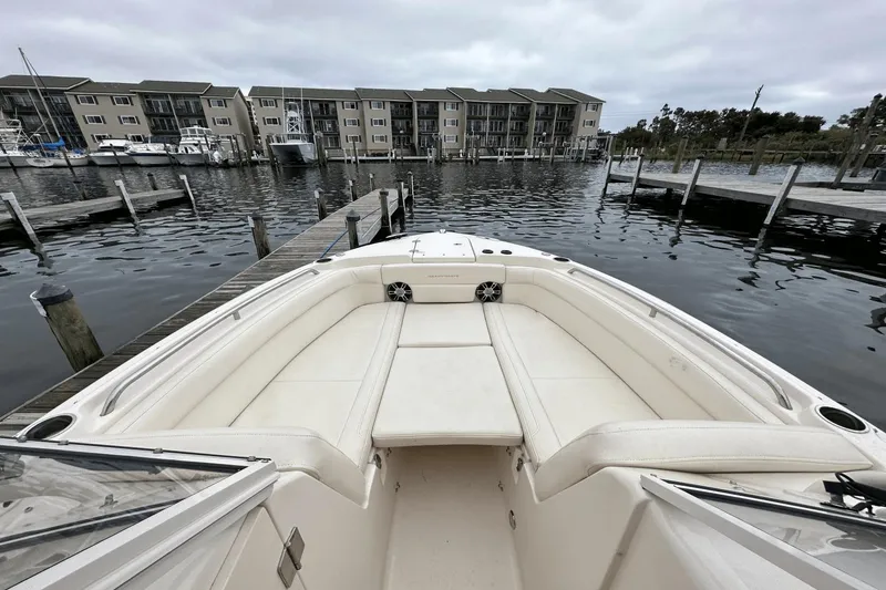 Slide: The Image of 2022 Grady-White 275 Freedom boat docked at marina with waterfront view. - 33