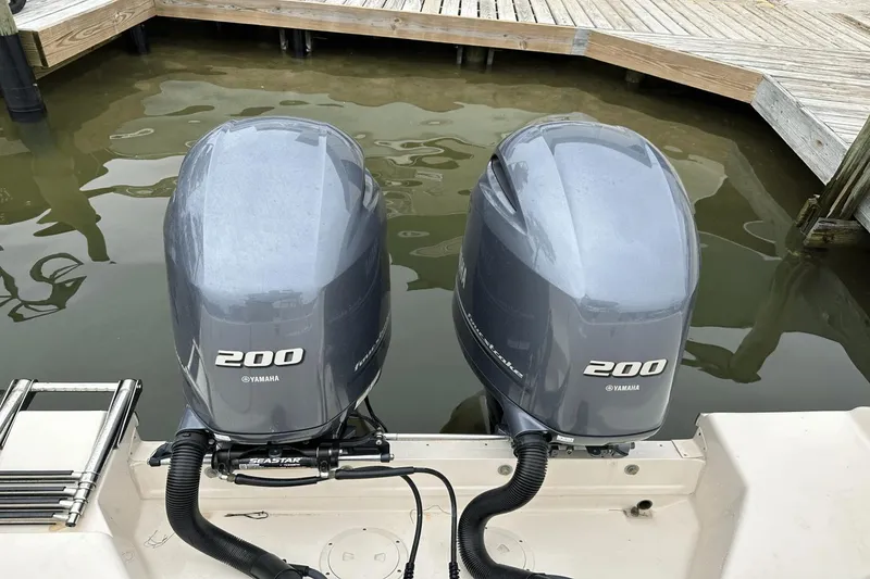 Slide: The Image of Twin Yamaha 200 engines on a 2022 Grady-White 275 Freedom boat at dock. - 6