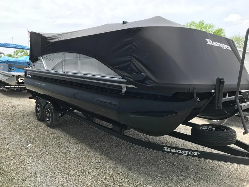 Slide: The Image of 2024 Ranger Reata 223C pontoon boat with black cover on trailer. - 15