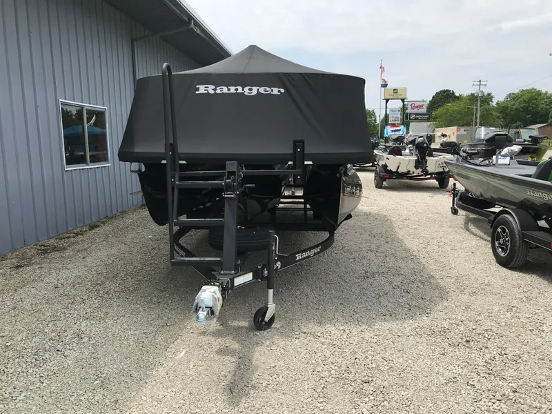 Slide: The Image of 2024 Ranger Reata 223C boat with cover in a dealership lot. - 16